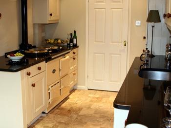 Fitted kitchen detail with dark work surface